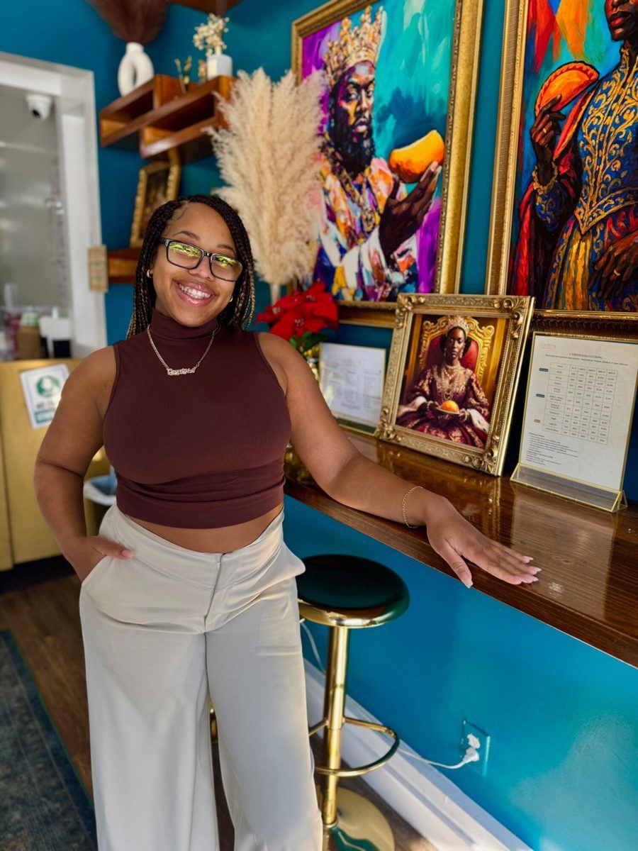Courtney smiling at the counter inside Courts Empanadas